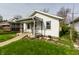 Charming single-Gathering home with a cozy front porch, landscaped with flowers, and a well-maintained lawn at 1510 Asbury St, Indianapolis, IN 46203