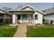 Charming single-Gathering home with a cozy front porch, landscaped with flowers, and a well-maintained lawn at 1510 Asbury St, Indianapolis, IN 46203