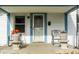 Inviting front porch featuring rocking chairs and planters, creating a warm and welcoming entry to the home at 1510 Asbury St, Indianapolis, IN 46203