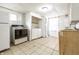 Kitchen featuring a refrigerator, oven, washer, and dryer at 1510 Asbury St, Indianapolis, IN 46203