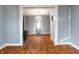 Open living room with hardwood floors featuring a fireplace, flowing into adjacent spaces with a neutral color scheme at 1510 Asbury St, Indianapolis, IN 46203