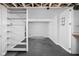 Unfinished basement with modular flooring and storage shelving ready for customization and ample storage at 157 E 61St St, Indianapolis, IN 46220