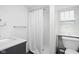 Clean bathroom design features a modern sink, shower with curtain, and toilet with storage shelf above at 157 E 61St St, Indianapolis, IN 46220