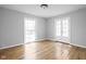 Sun-filled bedroom with hardwood floors, a large window, and access to a balcony at 157 E 61St St, Indianapolis, IN 46220