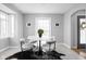 Dining area featuring a marble table, stylish chairs, tile flooring, and natural light at 157 E 61St St, Indianapolis, IN 46220