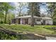 Charming single story brick home with white painted brick and mature trees at 157 E 61St St, Indianapolis, IN 46220