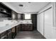 Well-lit kitchen featuring stylish cabinetry, stainless sink, and sliding-door pantry for organized storage at 157 E 61St St, Indianapolis, IN 46220