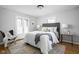 Comfortable main bedroom with neutral tones, French doors, and a decorative rug at 157 E 61St St, Indianapolis, IN 46220