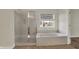 Bathroom with a separate shower and soaking tub under a window with exterior views, and a tile floor at 16271 Ambia Cir, Westfield, IN 46074