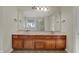 Bathroom with a double sink vanity, large mirror, drawers and a view of the shower and tub at 16271 Ambia Cir, Westfield, IN 46074