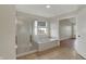 Bathroom with a shower and tub combination, a window, neutral walls, and an open doorway to another room at 16271 Ambia Cir, Westfield, IN 46074