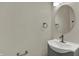 Clean bathroom with white sink, gray vanity, modern faucet, and round mirror at 16271 Ambia Cir, Westfield, IN 46074