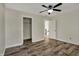 Bedroom featuring wood-look floors, a ceiling fan, an entry doorway, and a closet, with neutral walls at 16271 Ambia Cir, Westfield, IN 46074