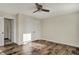 Bedroom featuring wood-look floors, a ceiling fan, an entry doorway, a closet, and neutral walls at 16271 Ambia Cir, Westfield, IN 46074