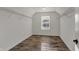 Walk-in closet with a window and wire shelving installed on the walls above the wood-look floor at 16271 Ambia Cir, Westfield, IN 46074