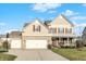 Charming home with a two-car garage, stone accents, and a well-maintained lawn at 16271 Ambia Cir, Westfield, IN 46074