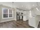 Open kitchen and dining area with white cabinetry, stainless appliances, and wood flooring at 16271 Ambia Cir, Westfield, IN 46074