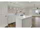 Bright kitchen features white cabinets, quartz countertops, and a center island at 16271 Ambia Cir, Westfield, IN 46074