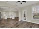 Open-concept living area showcases modern light fixture, white trim, and wood-look flooring at 16271 Ambia Cir, Westfield, IN 46074