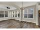 Bright living room with many large windows, modern lighting, and wood-look flooring at 16271 Ambia Cir, Westfield, IN 46074