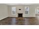 Bright living room with a fireplace, large windows, and hardwood floors at 16271 Ambia Cir, Westfield, IN 46074