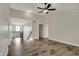 Spacious living area with hardwood flooring, stairwell access, and ceiling fan at 16271 Ambia Cir, Westfield, IN 46074