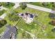 Overhead view of backyard with a well-kept lawn, trees, wooden fencing, deck, and a two-story house at 1652 Valley Brook Dr, Indianapolis, IN 46229