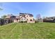 Spacious backyard featuring a well-manicured lawn, a wooden deck, and an exterior view of the two-story house at 1652 Valley Brook Dr, Indianapolis, IN 46229