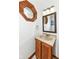 Bathroom featuring a stone countertop, vanity, framed mirror and unique octagonal window at 1652 Valley Brook Dr, Indianapolis, IN 46229