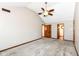 A carpeted bedroom features neutral walls, a ceiling fan, and natural wood doors leading to other spaces at 1652 Valley Brook Dr, Indianapolis, IN 46229