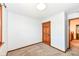 Bedroom boasts fresh paint, plush carpeting, and a stylish wood door leading to additional rooms at 1652 Valley Brook Dr, Indianapolis, IN 46229