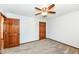A spacious bedroom features neutral walls, plush carpeting, a ceiling fan, and wood doors at 1652 Valley Brook Dr, Indianapolis, IN 46229