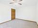 This bedroom has carpet flooring, a ceiling fan and a wood-look door at 1652 Valley Brook Dr, Indianapolis, IN 46229