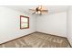 A bright bedroom with plush carpet, a window, and a modern ceiling fan overhead at 1652 Valley Brook Dr, Indianapolis, IN 46229