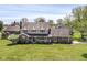 Inviting two-story home featuring a brick facade, complemented by a green lawn and mature trees at 1652 Valley Brook Dr, Indianapolis, IN 46229