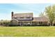 Traditional two-story house with brick accents, complemented by well-maintained landscaping and a spacious lawn at 1652 Valley Brook Dr, Indianapolis, IN 46229