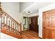 Welcoming foyer showcasing hardwood floors, a staircase, and a view into other living spaces at 1652 Valley Brook Dr, Indianapolis, IN 46229