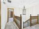 Hallway with wooden railing and chandelier leading to rooms at 1652 Valley Brook Dr, Indianapolis, IN 46229