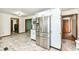 Well-lit kitchen with white cabinetry, stainless steel fridge, and unique patterned flooring at 1652 Valley Brook Dr, Indianapolis, IN 46229