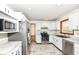 Modern kitchen featuring white cabinets, stainless steel appliances, and marble countertops and flooring at 1652 Valley Brook Dr, Indianapolis, IN 46229