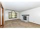 Bright living room featuring a charming fireplace, a window, and plush carpet at 1652 Valley Brook Dr, Indianapolis, IN 46229