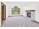 Spacious living room featuring a fireplace, large arched window, neutral walls, and neutral carpet at 1652 Valley Brook Dr, Indianapolis, IN 46229