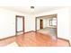 Bright living room with wood floors leading to a carpeted living room and entry to the kitchen at 1652 Valley Brook Dr, Indianapolis, IN 46229