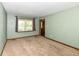 Neutral living room features plush carpeting, a window and natural light, with freshly painted walls at 1652 Valley Brook Dr, Indianapolis, IN 46229
