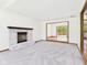 Bright living room with fireplace and sliding glass doors to deck at 1652 Valley Brook Dr, Indianapolis, IN 46229