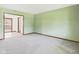 Light-filled living room with neutral walls, neutral carpet, natural wood trim, and open doorway at 1652 Valley Brook Dr, Indianapolis, IN 46229