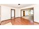 Bright living room with wood floors leading to a carpeted living room and entry to the kitchen at 1652 Valley Brook Dr, Indianapolis, IN 46229
