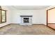Living room featuring a charming fireplace, a window, and plush carpet at 1652 Valley Brook Dr, Indianapolis, IN 46229