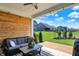 Cozy covered patio with wood accent wall, comfortable seating and tranquil backyard views at 16683 Alex Dr, Noblesville, IN 46060