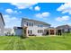 A lovely two-story home with a spacious lawn, patio seating area and beautiful outdoor pergola at 16683 Alex Dr, Noblesville, IN 46060